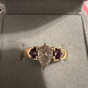 Beautiful 3/4 caret Diamond solitaire with genuine rubies on the side.